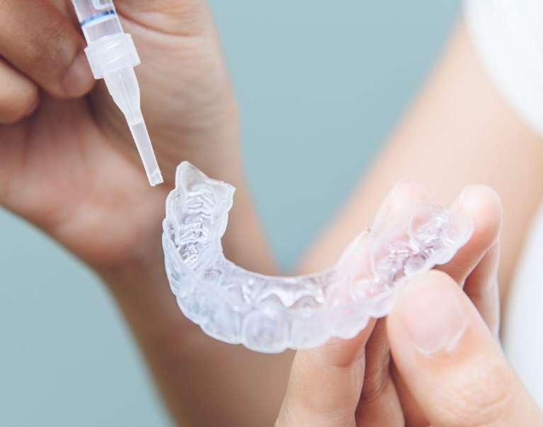 Patient using Pola take-home whitening trays in Doreen